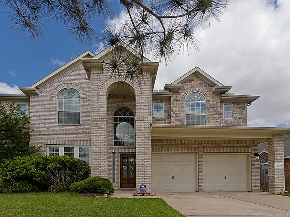 Grand Stone and Brick elevation and beautiful front yard.
