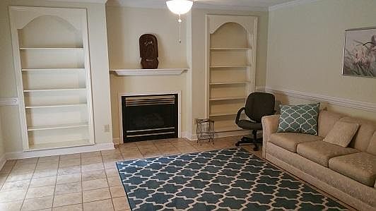 Living room, fireplace not functional, not showing to the left is a sliding door with blinds