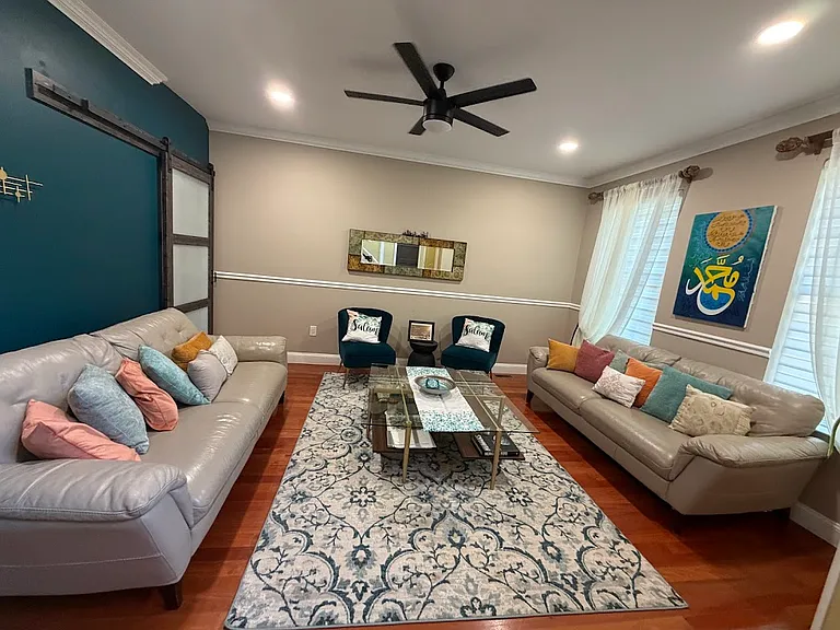 Formal living room with sliding barn door, leading to the kitchen
