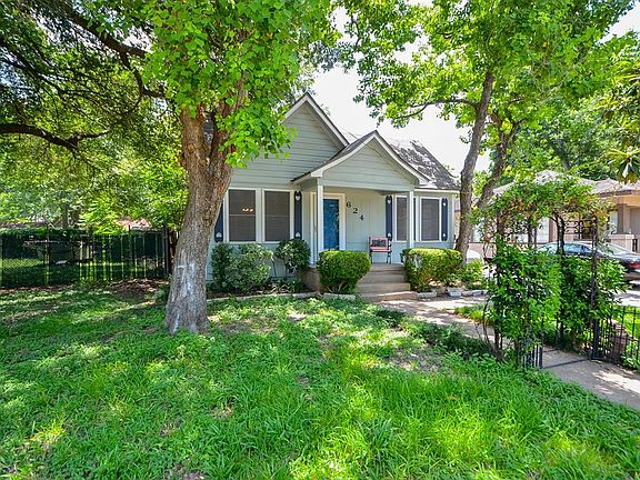 This adorable home has enchanting curb appeal with entry arch and covered porch