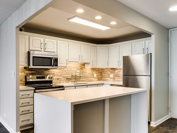 Open kitchen with quartz counters and brand new appliances