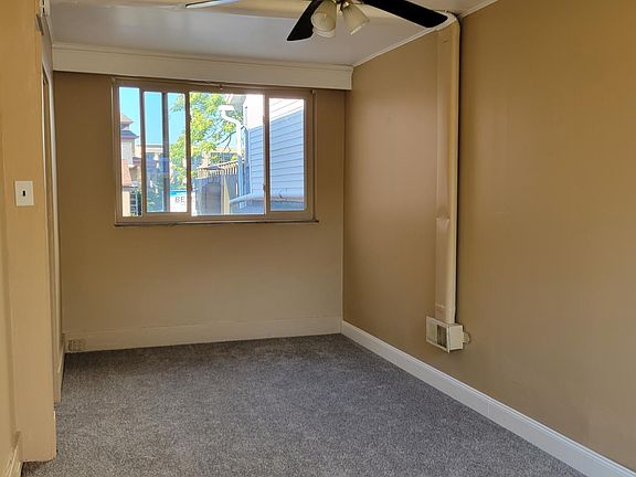 Living room, freshly-painted, new carpet.