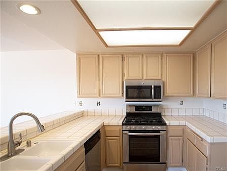 The bright & airy kitchen offers an abundance of counter space and storage options.