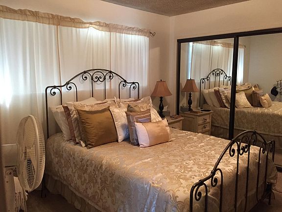 Bedroom with mirrored closet sliders