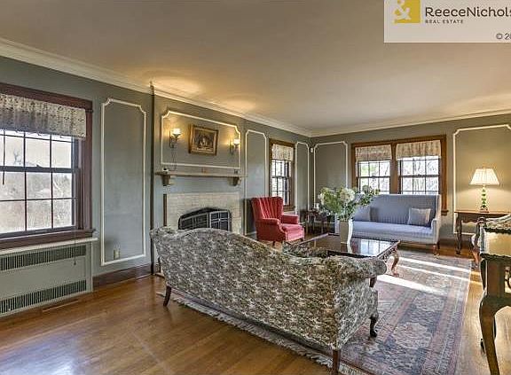 Travertine fireplace sits at the heart of the living room.  You'll love the wooded views too!