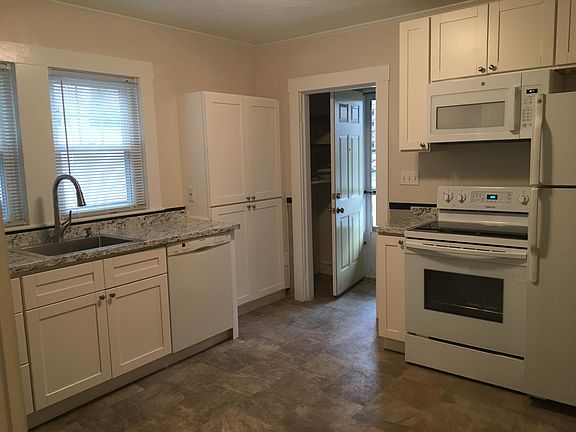 Newer Kitchen w/ Flat top Convection Stove & Built - In Microwave, Dishwasher & Disposal