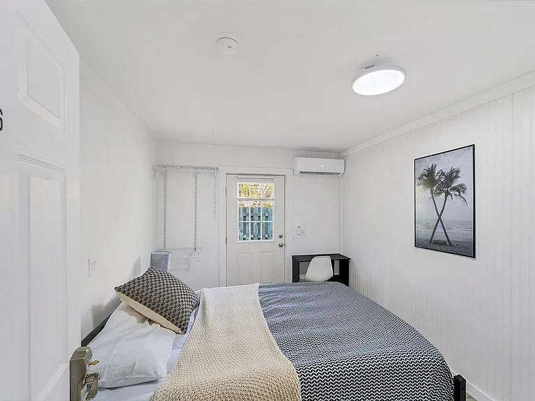 Cozy bedroom with private entrance and queen bed.
