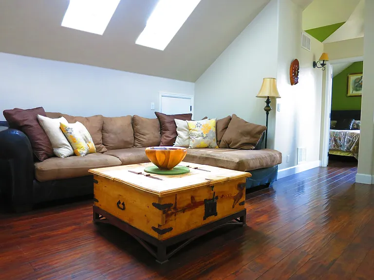 The living room is located between the two bedrooms upstairs