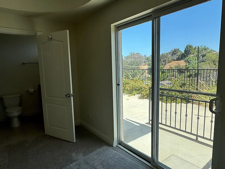 Second Master Bedroom with on suite Bathroom with sliding doors to backyard.