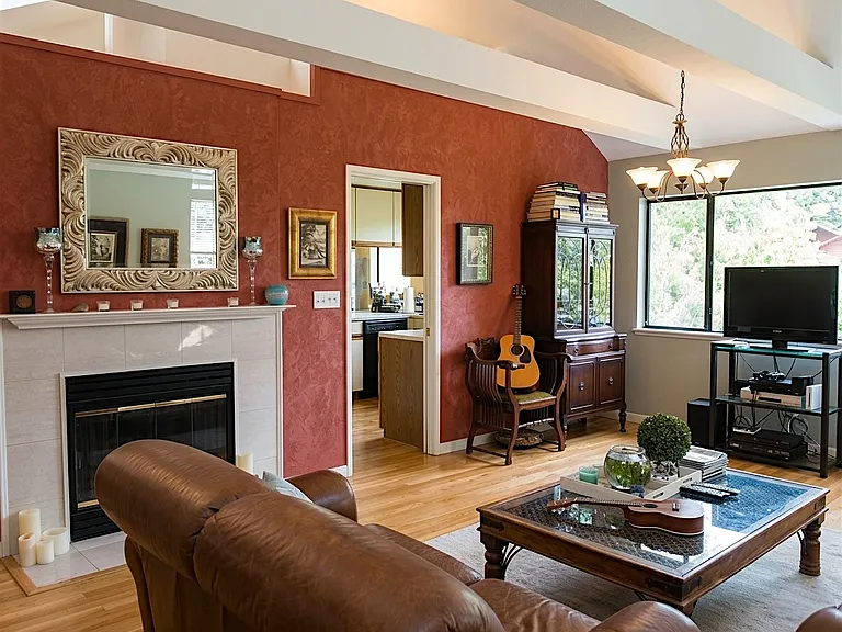 Living room: vaulted ceiling, tract lighting, working fire place, opens to kitchen. Half bath upstairs. There is deck off the living room!