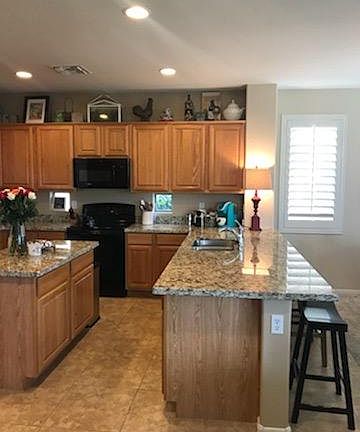 Kitchen with island and barstool counter area