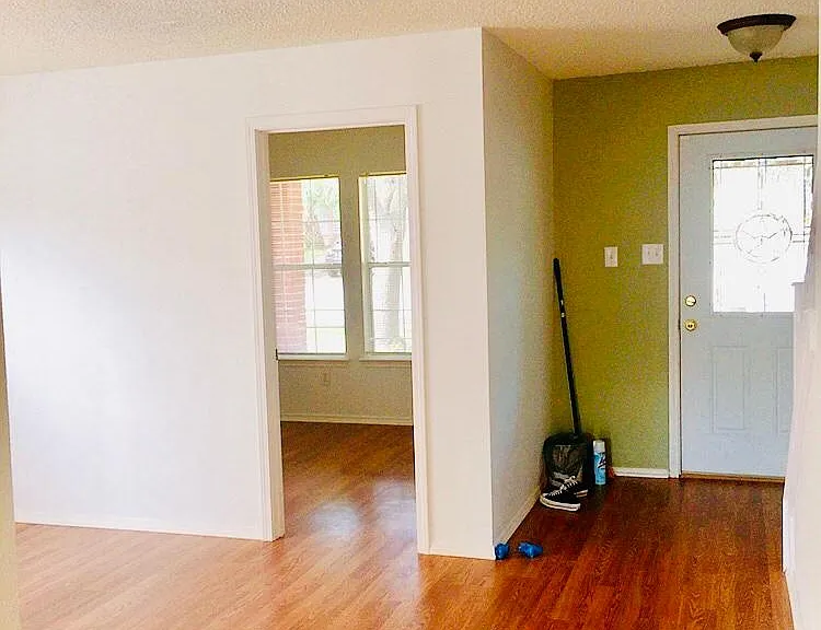 Entering the main door, you will find a bedroom on your right side with windows.