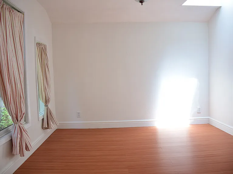 Bedroom w skylight and furnished w queen bed