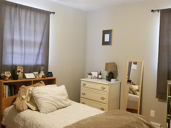 The three bedrooms are large, with closets, windows, and hardwood floors.