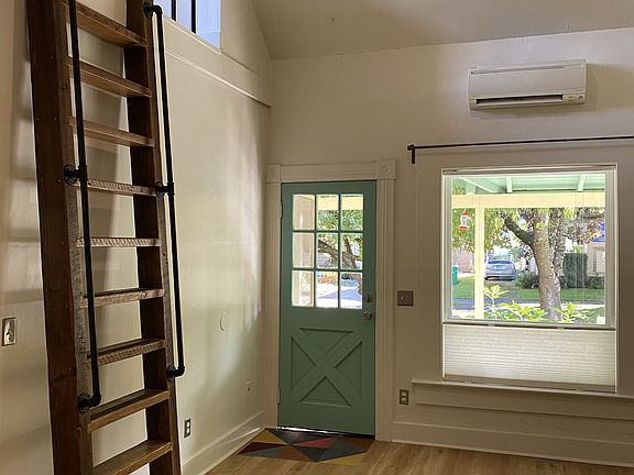 Front door entrance, porch and heat pump.