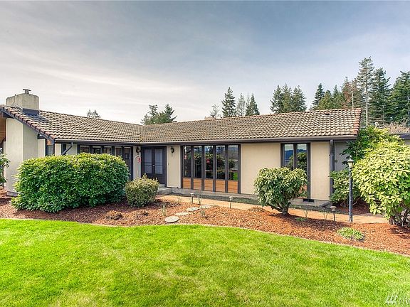 Front yard view of this desirable Edgewood rambler.  An abundance of windows and tile roof add to its character and appeal.