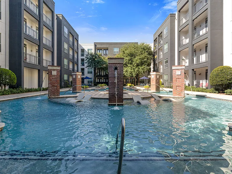 Expansive swimming pool with poolside loungers