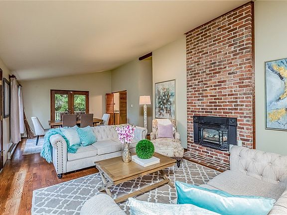 The front door opens to the Great Room with a bricked gas fireplace anchoring the room