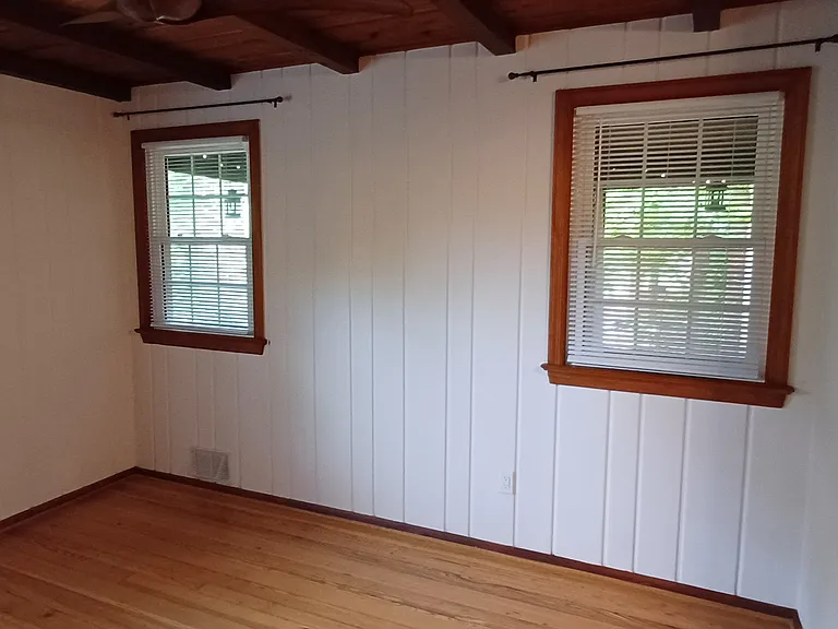 1st floor bedroom with windows to screened porch. Closet door on right.