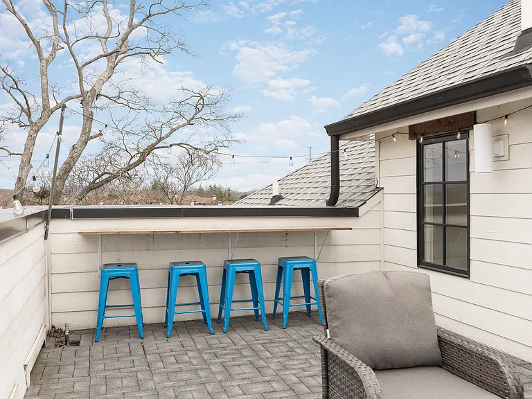 Private rooftop deck with plenty of seating and outdoor lights, allowing you to enjoy your morning cup of coffee or a late night conversation while overlooking the skyline.