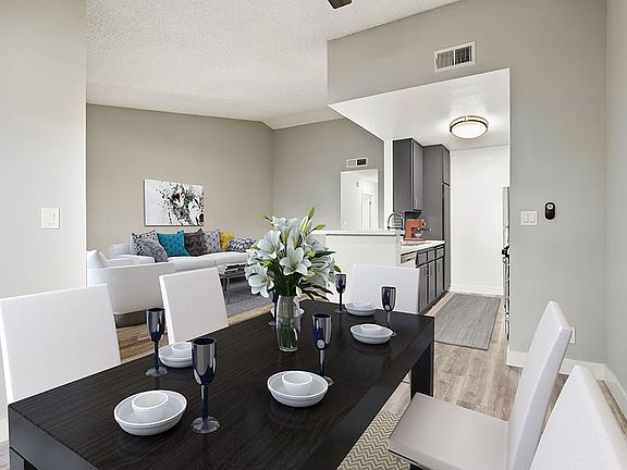 Hardwood floored dining room with view of living room.