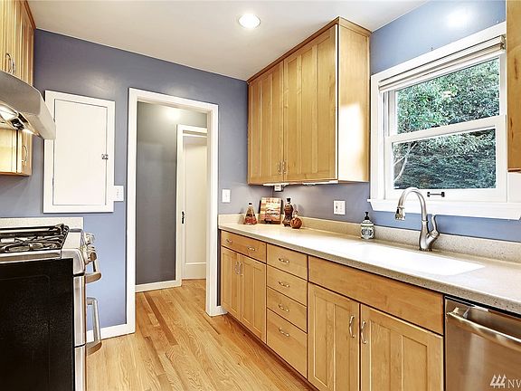 Another angle of the kitchen with window looking out to the backyard.