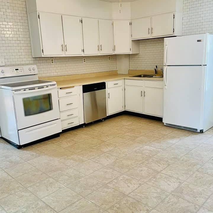 Updated kitchen with electric stove, dishwasher, fridge and ample cabinet storage