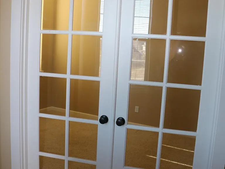 Entrance to Den/Office with French Doors and transom window above the doors.