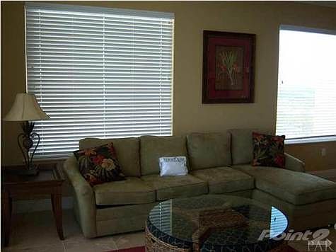 Spacious living room features travertine flooring.