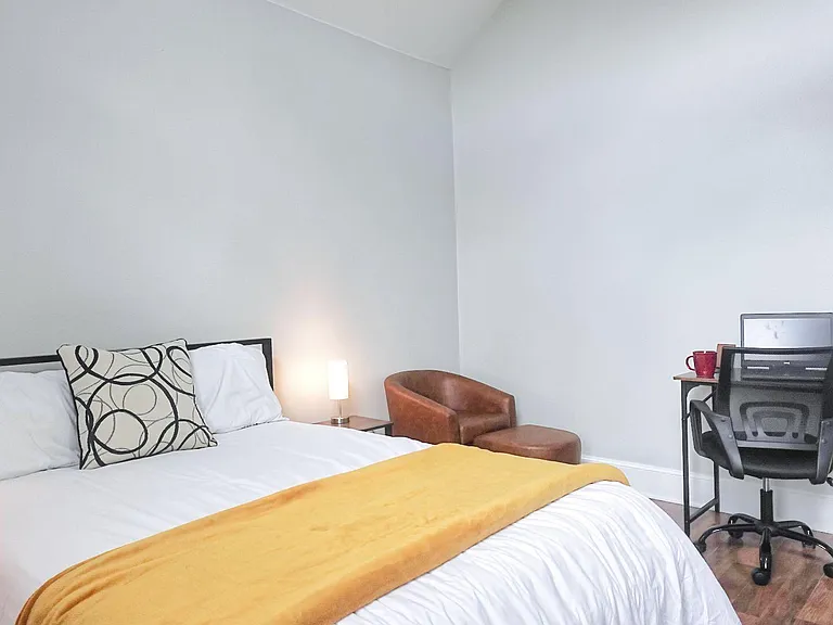 Bed with a lounge chair and an ottoman