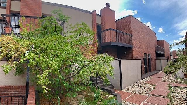 Front entrance from beautiful private inner courtyard with the two private townhome balconies at the center.