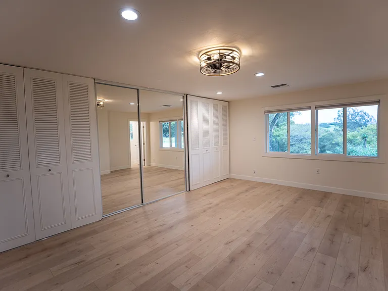 Very spacious primary bedroom with views to the front of the property, entire wall of closets with en suite bathroom.