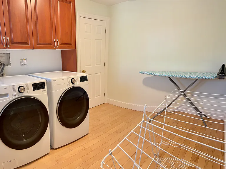 New LG washer and dryer in the spacious 2nd floor laundry room includes ironing board, iron and clothes drying rack
