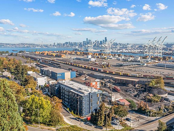 Take in the stunning aerial view of the port, showcasing the vibrant surroundings and the proximity of Harbor Flats to the waterfront.