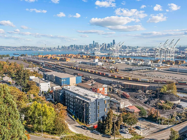 Take in the stunning aerial view of the port, showcasing the vibrant surroundings and the proximity of Harbor Flats to the waterfront.