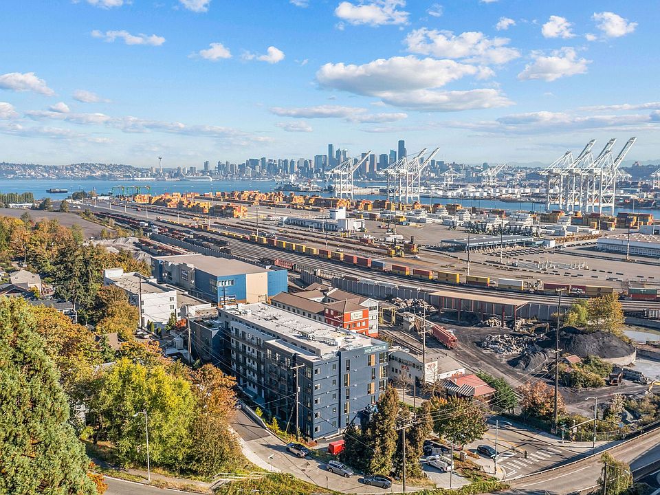Take in the stunning aerial view of the port, showcasing the vibrant surroundings and the proximity of Harbor Flats to the waterfront.