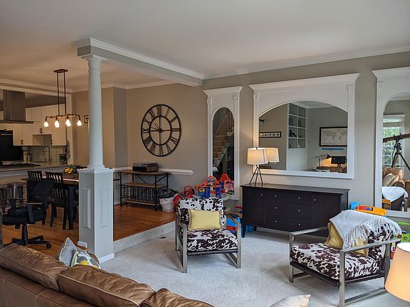 Living and dining room. Custom mirrors and lighting make the space welcoming