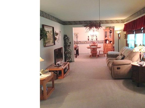 Open view from the entry door through the living room into the dining room