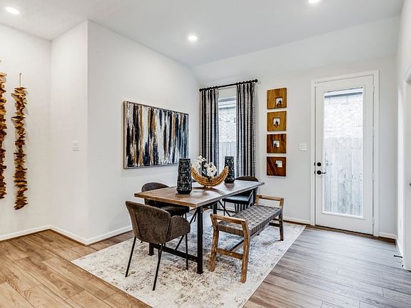 A dining room is tucked into the corner of the living area across from the kitchen and offers a plac