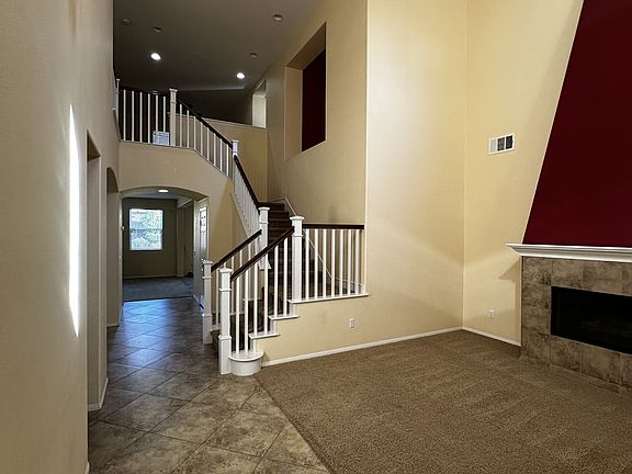 entry way and formal living room with fireplace