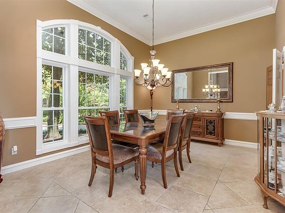 Formal dining room sits at the front of the home offering an abundance of natural light and exquisite chandelier