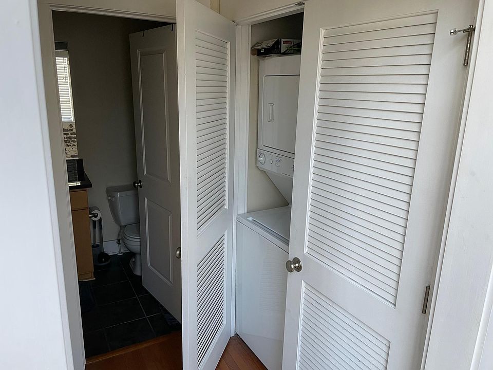 Oversized washer and dryer just outside of the bathroom and directly across from the linen closet.