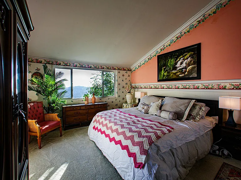 Master bedroom with an incredible view of the sprawling city below, vaulted ceiling, new carpeting, bathroom attached.