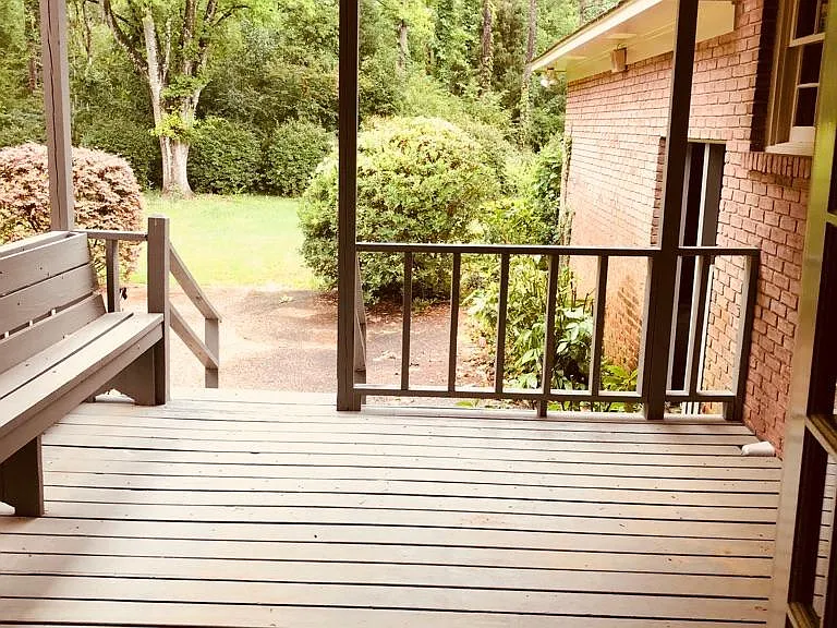 Deck off of Den-- opening to carport. Hughe back yard