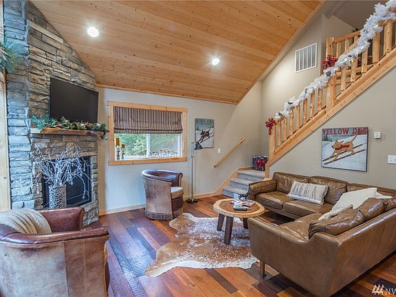 Custom log railing leads to open loft.