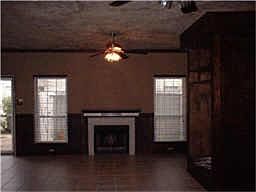 view of woodburning fireplace from kitchen. Notice the beautiful tile floors.
