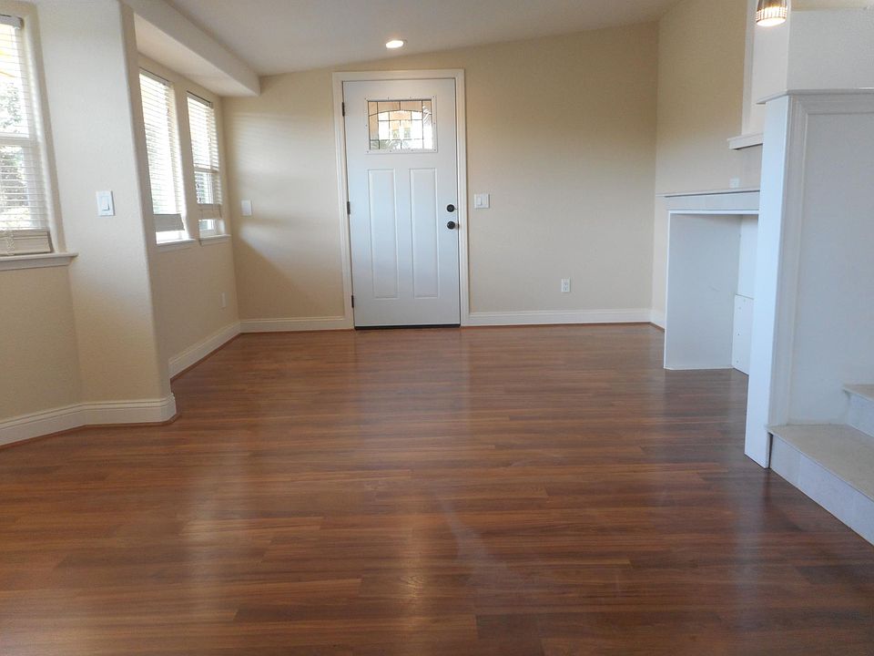 Living room area with built in countertop for dining or work station Lots of windows to enjoy the view of the surrounding hills. Recessed lighting.
