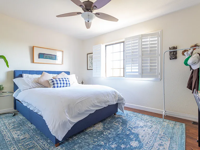 Guest bedroom with views of Montini hillside. 55" TV on the wall. Desk setup.
