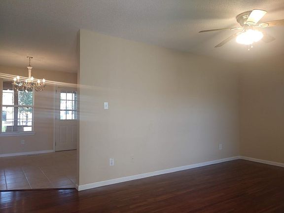 View from entering the front door. Living room to the right. Dining area through opening.