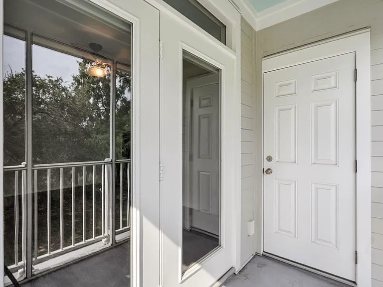 Updated screen porch, all new doors and windows throughout. This is accessed off the living room, and includes a large storage room.